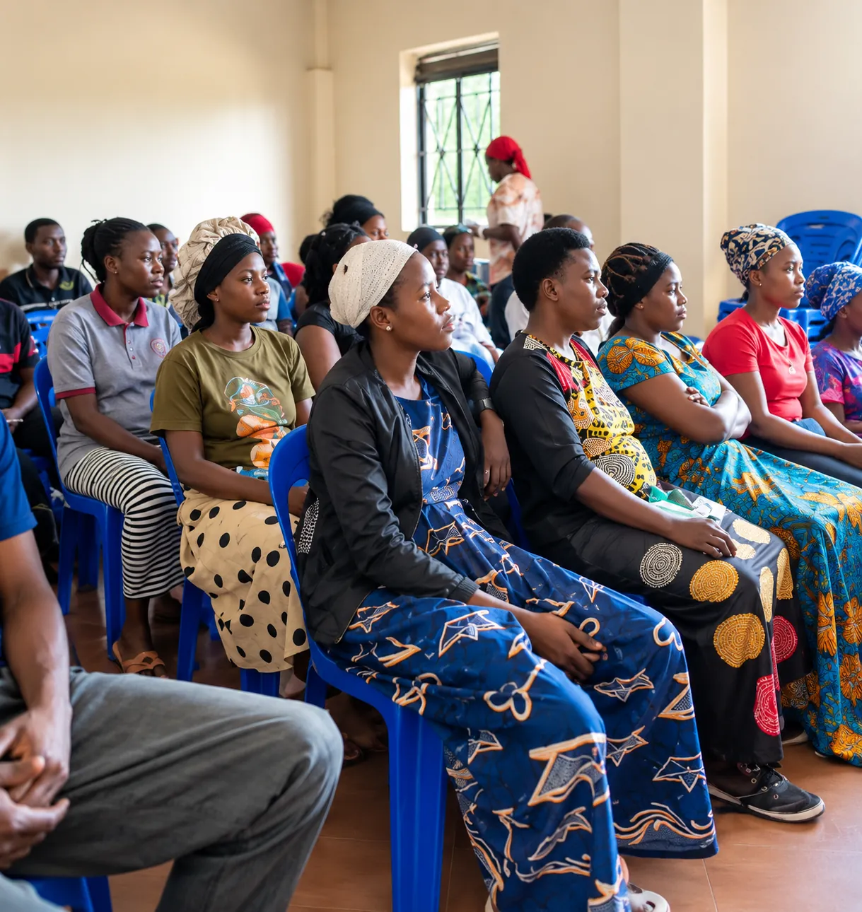 Women seated together at a community meeting